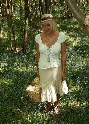 Blond milf undressed on a picnic in the forest