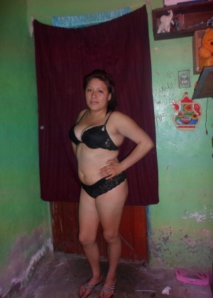 A plump Mexican woman is completely naked